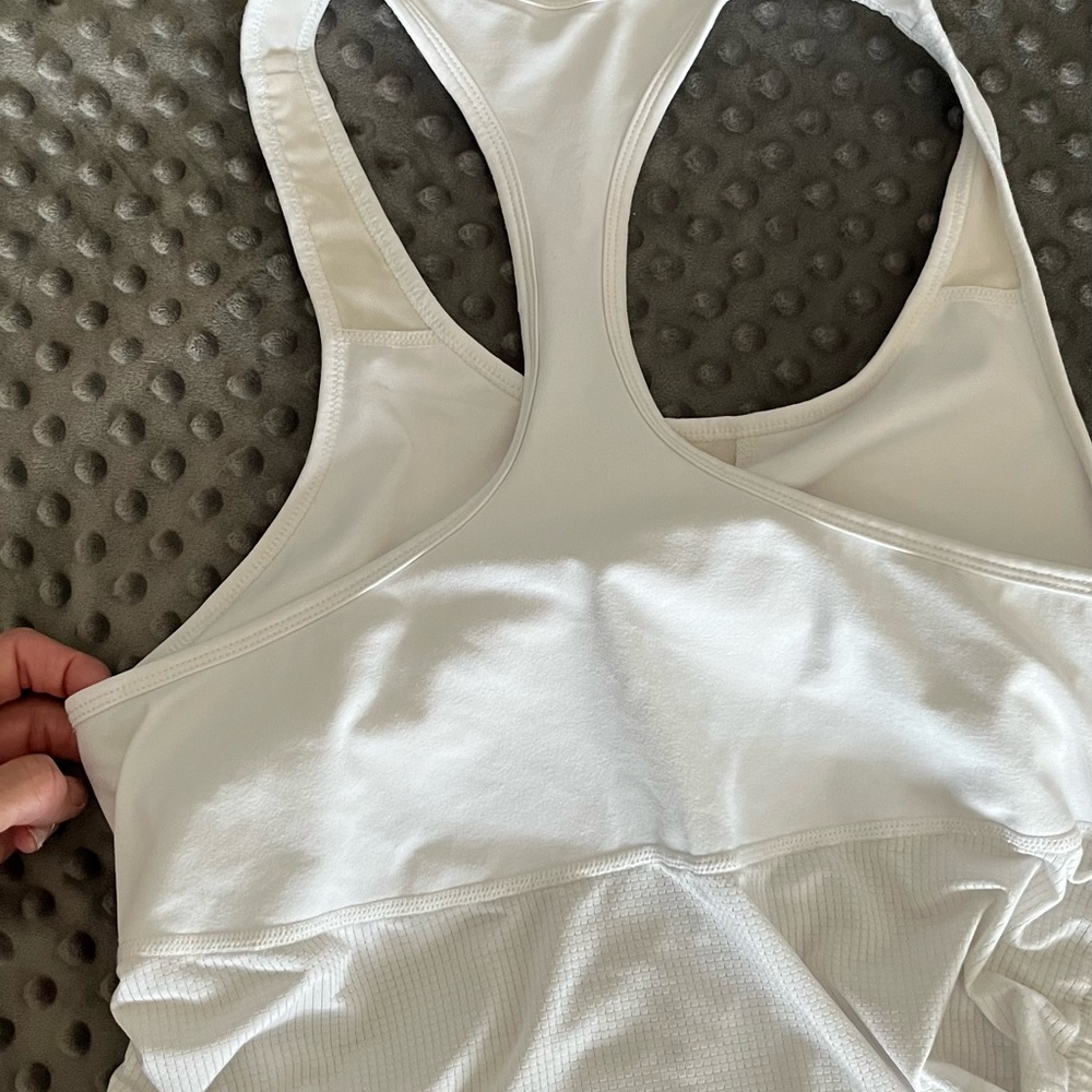 Athletic top. Size isn’t shown but it’s a medium fits snug. Side scrunch.